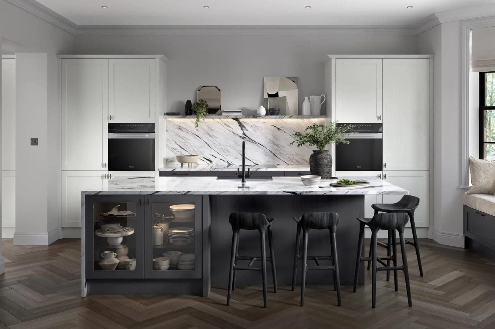 Cream shaker kitchen with navy island, dramatic veined marble splashback and worktop